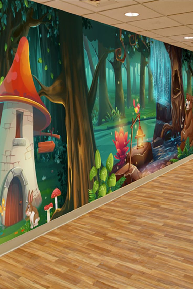 an empty room with a mural on the wall and wood flooring in front of it