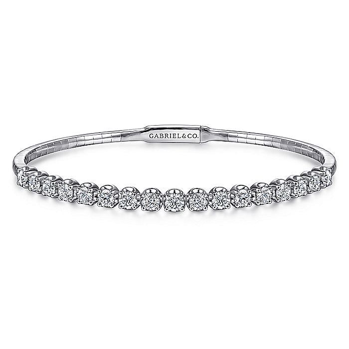 The perfect addition to your ring stacking can be found in this Demure collection bangle that is a chic showcase of modest glamor. Its delicate foundation is made of a delicate base of 14K white gold. Halfway towards the bangle's centerpiece is a extravagant row of round 1.93 ct diamond stations. Giving off an illuminating sparkle, this bangle is versatile enough to wear solo or combine with an assortment of your favorite stackable bracelets. Cheap White Bangle Jewelry, Elegant Stackable Diamond Bracelet For Anniversary, Classic Stackable Diamond Bracelet For Wedding, Modern White Diamond Bracelet For Wedding, Classic White Gold Bangle For Wedding, Modern Wedding Bangle With Diamond Accents, Minimalist Wedding Bangle With Diamond Accents, Elegant Stackable Diamond Bracelet For Wedding, Elegant Stackable Bangle For Anniversary