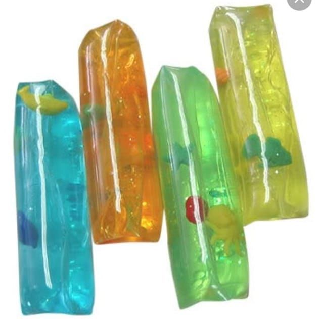 there are five plastic toys in the shape of toothbrushes with words on them