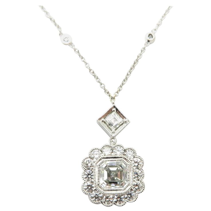 Platinum and 14K white gold GIA certified asscher and round diamond bezel set necklace. Centering one asscher cut GIA certified diamond weighing approximately 1.00 carat. Diamond grading: color grade: G. Clarity grade: VS2. Displaying one Asscher cut diamond, prong set in an illusion square style setting, weighing approximately 0.13 carats. Interspersed with 14 round brilliant cut diamonds on the pendant itself and an additional 14 round brilliant cut bezel set diamonds on the chain, weighing ap Octagon Brilliant Cut Diamond Necklace Gift, Octagon Brilliant Cut Diamond Necklace For Gift, Brilliant Cut Diamond Octagon Necklace Gift, Brilliant Cut Octagon Diamond Necklace For Gift, Heirloom White Gold Necklace With Single Cut Diamonds, Luxury Octagon Diamond Necklace With Diamond Accents, Luxury Diamond Necklace With Octagon Diamond Accents, Luxury Octagon Diamond Necklace With Accents, Timeless Octagon Rose Cut Diamond Jewelry