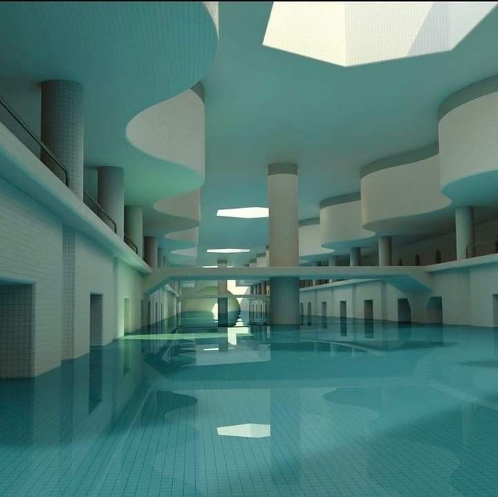 an empty swimming pool in a large building