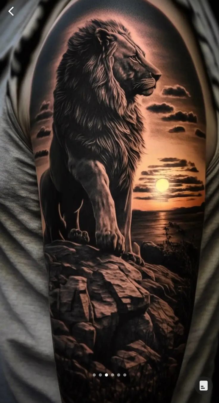 a man's arm with a lion on it and the sun in the background