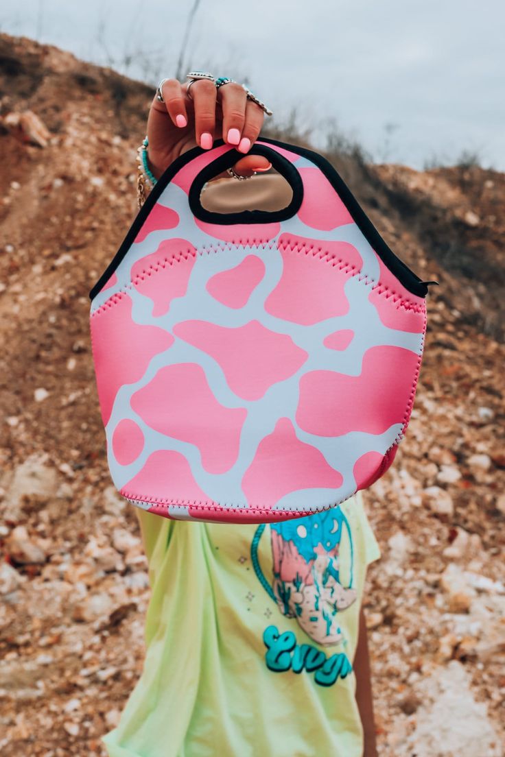 The Pink Cowhide Lunch Tote is perfect for school or work lunches. It's made of neoprene which is wipeable; or throw the whole lunch bag in the washing machine on "gentle cycle"! Lightweight and condensation free. Wide bottom that accommodates most food containers. Folds flat for easy stashing post-lunch! Top handles are great for grab and go lifting. Lunch with style! Trendy Lunch Bag For Back To School Travel, Trendy Lunch Bag For Back To School, Casual Summer Lunch Bag For Travel, Large Capacity Pink Lunch Bag, Casual Summer Travel Lunch Bag, Pink Lunch Bag With Zipper, Trendy Pink Lunch Bag For School, Pink Large Capacity Tote Lunch Bag, Large Capacity Pink Tote Lunch Bag