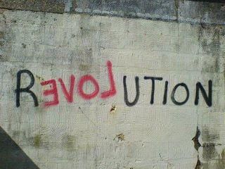 graffiti on the side of a building that says revolution written in red and black ink