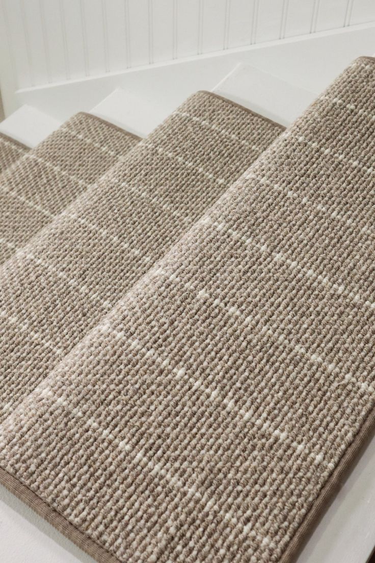 two rugs sitting on top of a white counter