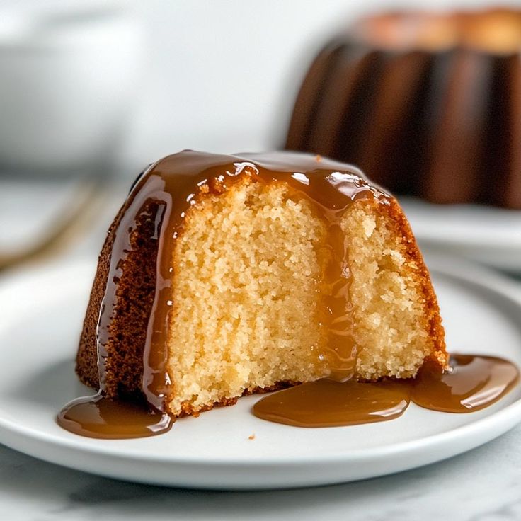 a piece of cake on a plate with caramel sauce drizzled over it