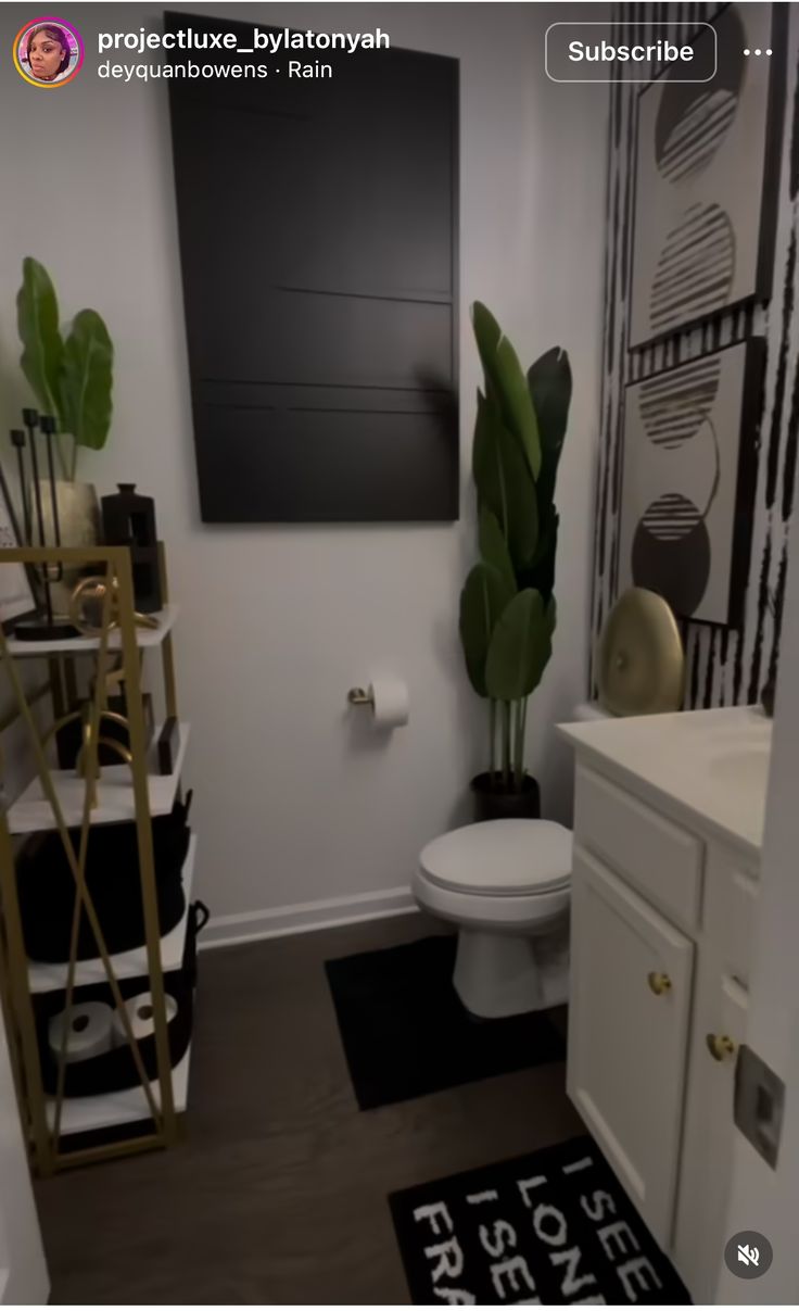 a white toilet sitting in a bathroom next to a plant