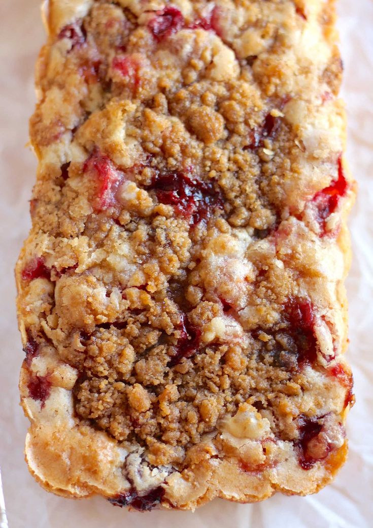 a close up of a piece of bread with crumbs and topping on it