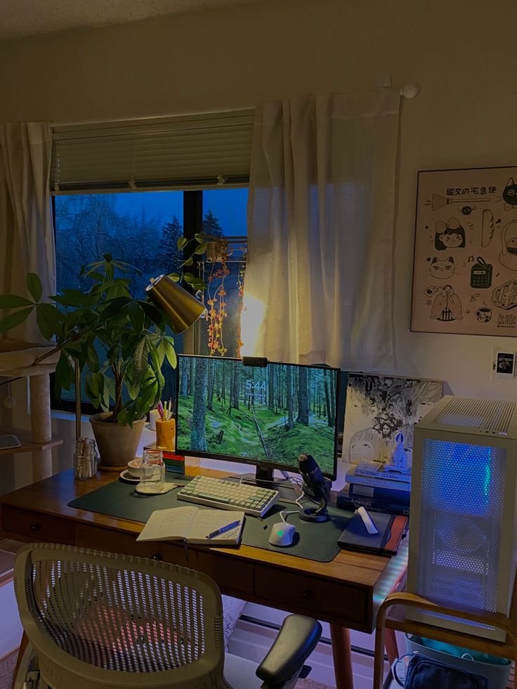 a desk with a computer monitor, keyboard and mouse on it in front of a window