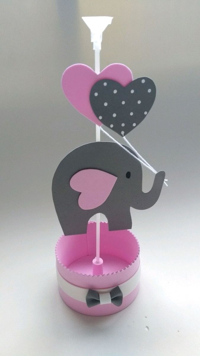 an elephant with a heart on its trunk in a pink cupcake holder and umbrella