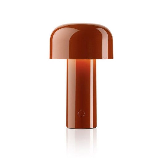 an orange table lamp on a white background