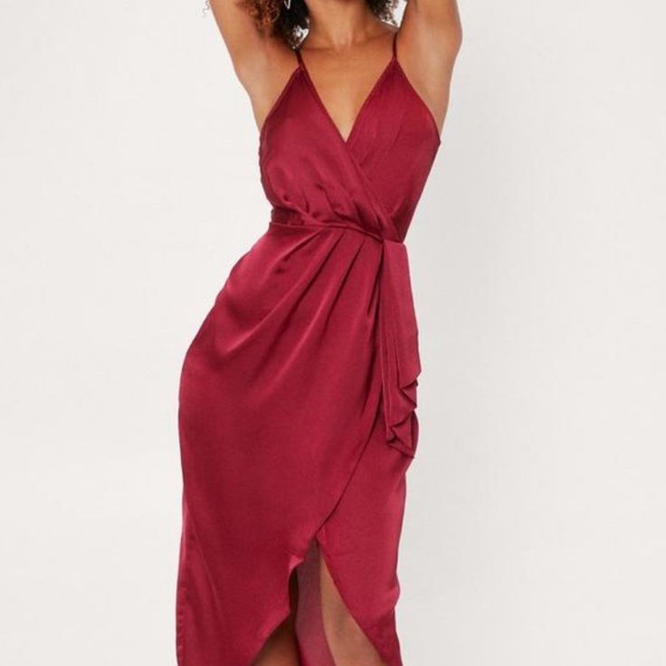 This Dress Comes In Satin And Features A Midi Silhouette, V-Neckline, Wrap Design, Adjustable Straps, And Zip Closure At Back. Sold Out Style. Chic Spaghetti Strap Wrap Dress For Party, Chic Wrap Dress With Spaghetti Straps For Party, Red V-neck Dress For Date Night, Red V-neck Midi Dress For Dinner, Red V-neck Midi Party Dress, Chic Burgundy V-neck Mini Dress, Burgundy Satin V-neck Dress, Satin Midi Dress With Surplice Neckline For Party, Satin V-neck Wrap Dress For Cocktail