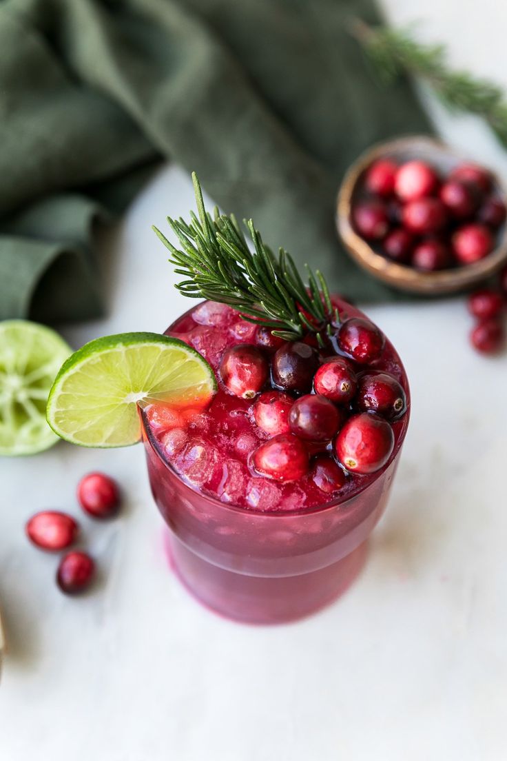 a glass filled with cranberry and lime juice