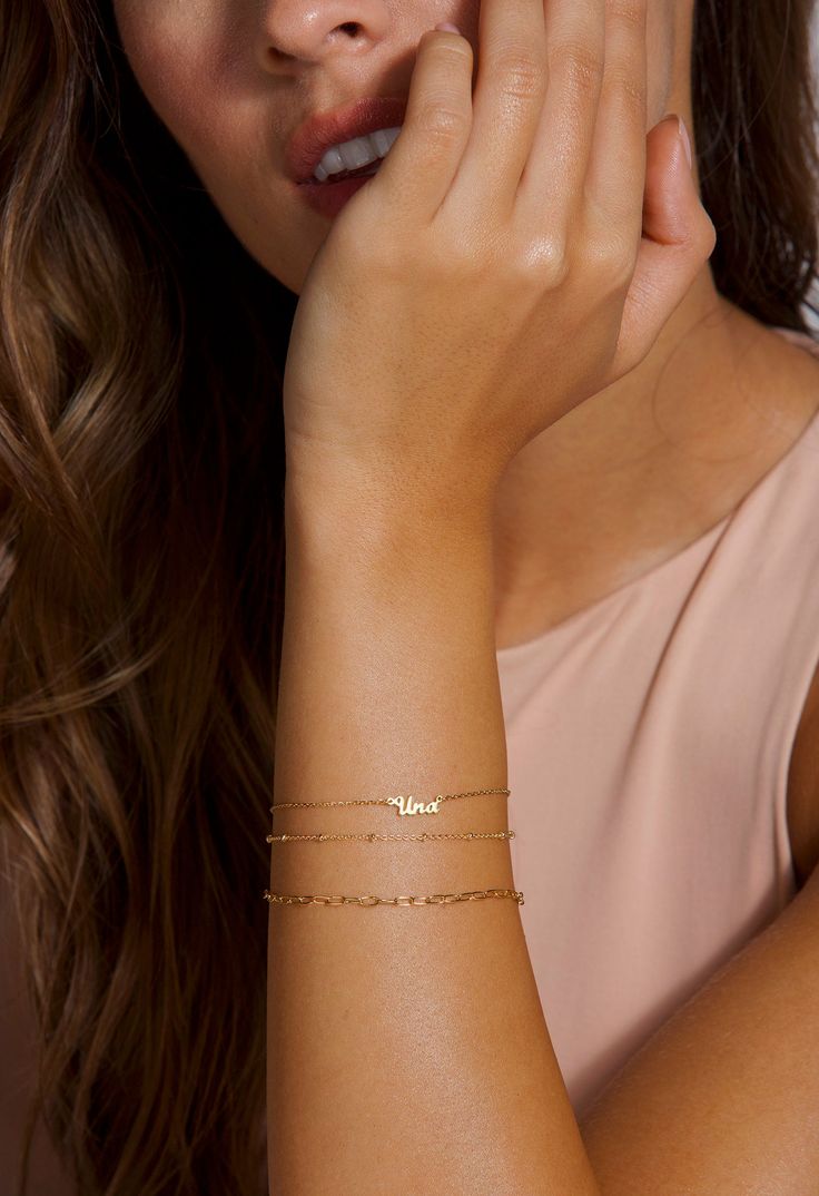 The prettiest personalized gold bracelet gift for women! Layer as shown or wear it alone! DETAILS: Model is wearing a 14k solid gold personalized name bracelet. This item includes only the name bracelet, for the layered options bracelets see links below. LAYERING LOOK: Beaded Bracelet: https://www.etsy.com/listing/736956390/beaded-satellite-bracelet-gold-beaded?ref=shop_home_active_17&pro=1&frs=1 Open Link Bracelet: https://www.etsy.com/listing/737308052/gold-link-bracelets-gold-bracelet Dainty Custom Name Bracelet In 14k Gold, Dainty 14k Gold Bracelet With Custom Name, Dainty Personalized 14k Gold Name Bracelet, Dainty Name Bracelet For Everyday Wear, Minimalist 14k Gold Bracelet For Personalized Gift, Custom Name 14k Gold Dainty Bracelet, Dainty Everyday Bracelets With Name, Dainty 14k Gold Custom Name Bracelet, Dainty Yellow Gold Bracelet With Custom Name