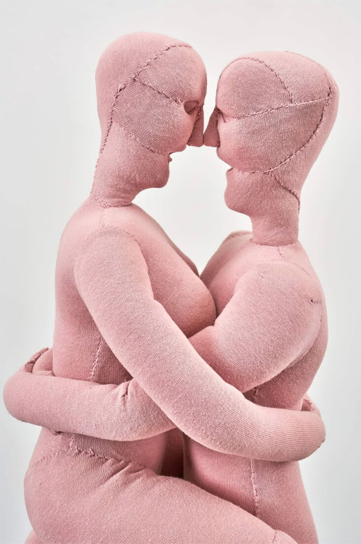 two people in pink bodysuits hugging each other