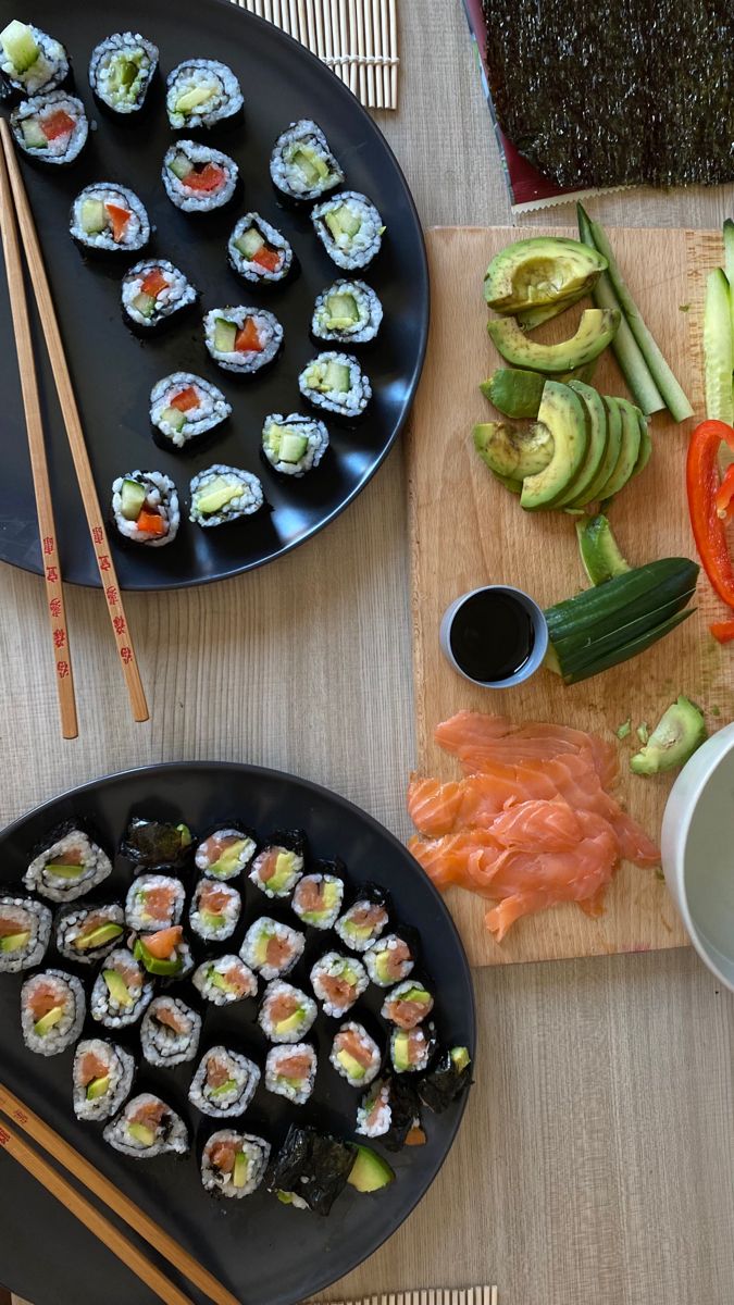 sushi and chopsticks are on the table ready to be eaten