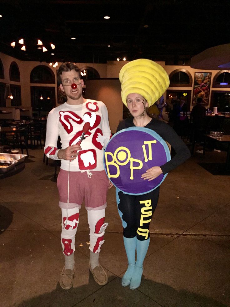 two people dressed in costumes standing next to each other