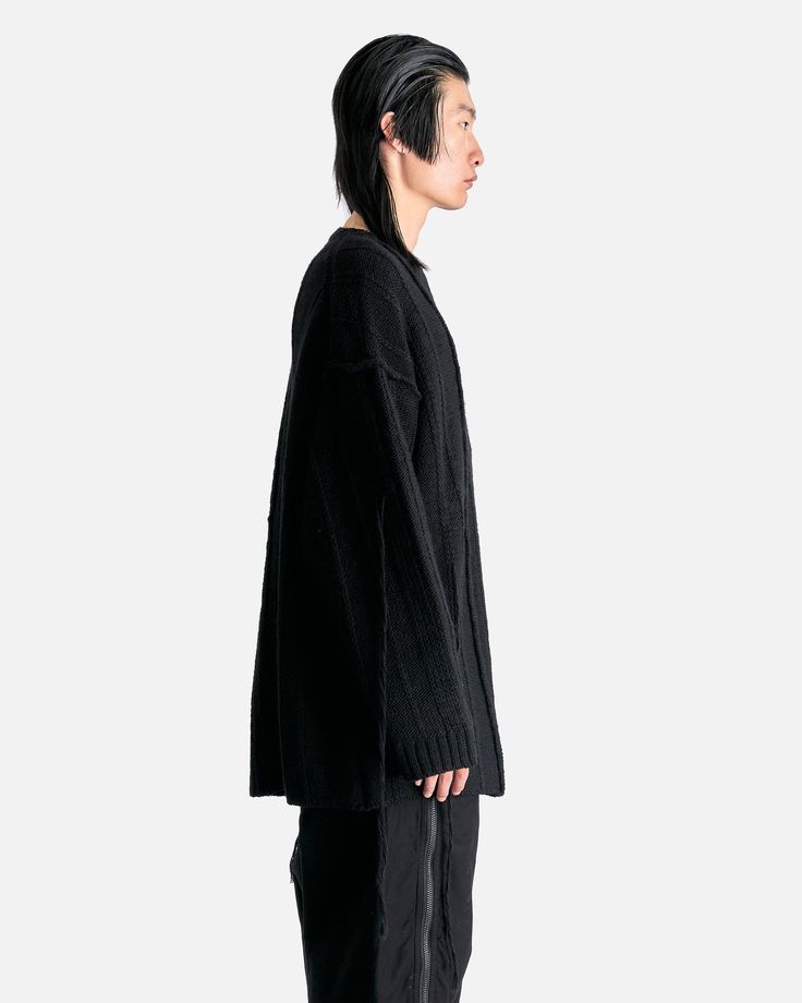 Yohji Yamamoto Pour Homme String Switching Round Neck in Black. This oversized sweater features vertical knit detailing, ribbed crewneck, cuffs, and hem, dropped shoulder seams, loose knit detail at the arm and rear and a straight hem. Oversized Ribbed Long Sleeve Sweater, Oversized Ribbed Crew Neck Cardigan, Oversized Sweater With Ribbed Neckline For Streetwear, Oversized Ribbed Sweatshirt For Layering, Oversized Black Cardigan With Ribbed Cuffs, Oversized Ribbed Crew Neck Outerwear, Oversized Ribbed Knit Sweatshirt, Jenny Bird, Clare V.