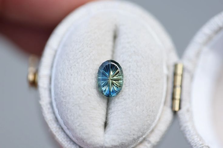 a close up of a ring with a blue stone in it's center and inside