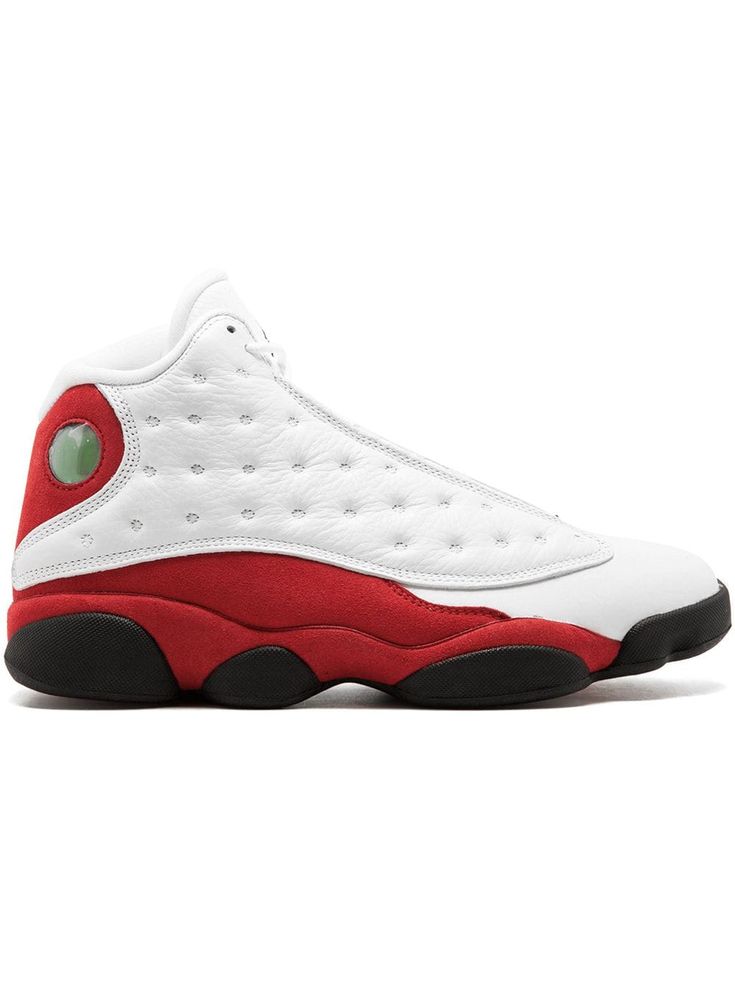 a white and red sneaker with black soles