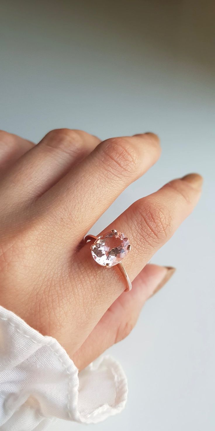 RING DETAILS: ✪Design: Gold ring ✪Gemstone: AA Morganite ✪Gemstone color: Pink ✪Gemstone shape: Oval ✪Gemstone transparency: Transparent ✪Gemstone size: Morganite- 9X11mm ✪Gemstone weight: Morganite- 3 carat ✪Setting type: Prong setting ✪Metal type: 14k rose solid gold ✪Gold weight: 2.13 gm ✪Metal finish: Smooth shiny Choose your ring size from drop down menu and if you need any other preferred ring size please contact us. QUALITY OF MATERIALS: Metal: Most of our jewelry at JewelryMansion is mad Oval Morganite Jewelry For Proposal, Oval Morganite Wedding Ring With Brilliant Cut, Rose Gold Morganite Topaz Ring, Morganite Solitaire In Rose Gold, Morganite Oval Rings With Brilliant Cut, Oval Blush Rings For Wedding, Blush Oval Rings For Wedding, Blush Oval Wedding Rings, Oval Solitaire Ring In 14k Rose Gold