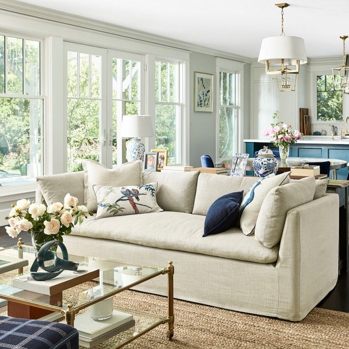 a living room filled with furniture and lots of windows