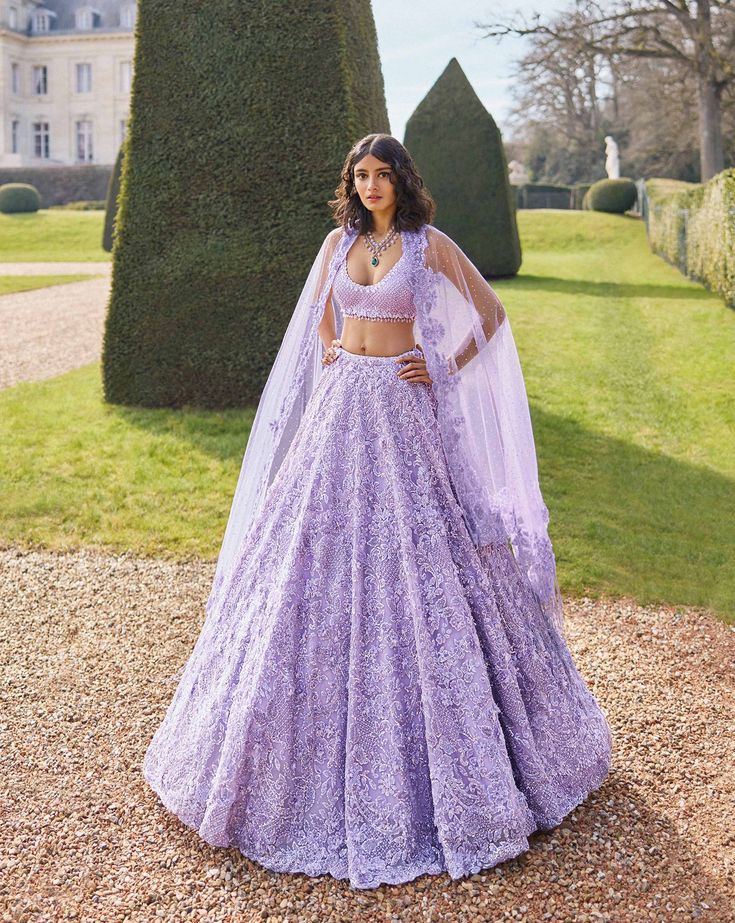 This lehenga set features intricate tonal sequin, beads and crystal embroidery. The blouse has a plunging neckline and comes with four sided embroidered net dupatta with long beaded tassels.From Seema Gujral's Love Notes From Paris Collection DELIVERY TIMEPlease allow 8-12 weeks for your outfit to arrive. FABRIC DETAILSNet Professional cleaning only. Purple Pastel Lehenga, Punjabi Bride Wedding Outfits, Indian Sweet Sixteen Dresses, Lengha Dress Gowns, Lilac Sangeet Outfit, Lilac Wedding Lehenga, Light Purple Lehenga Bridal, Lavender Bridal Lengha, Ring Ceremony Lehenga