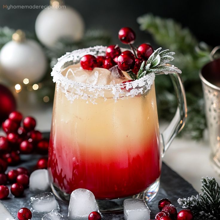 a drink in a glass with ice and cranberry garnish on the rim