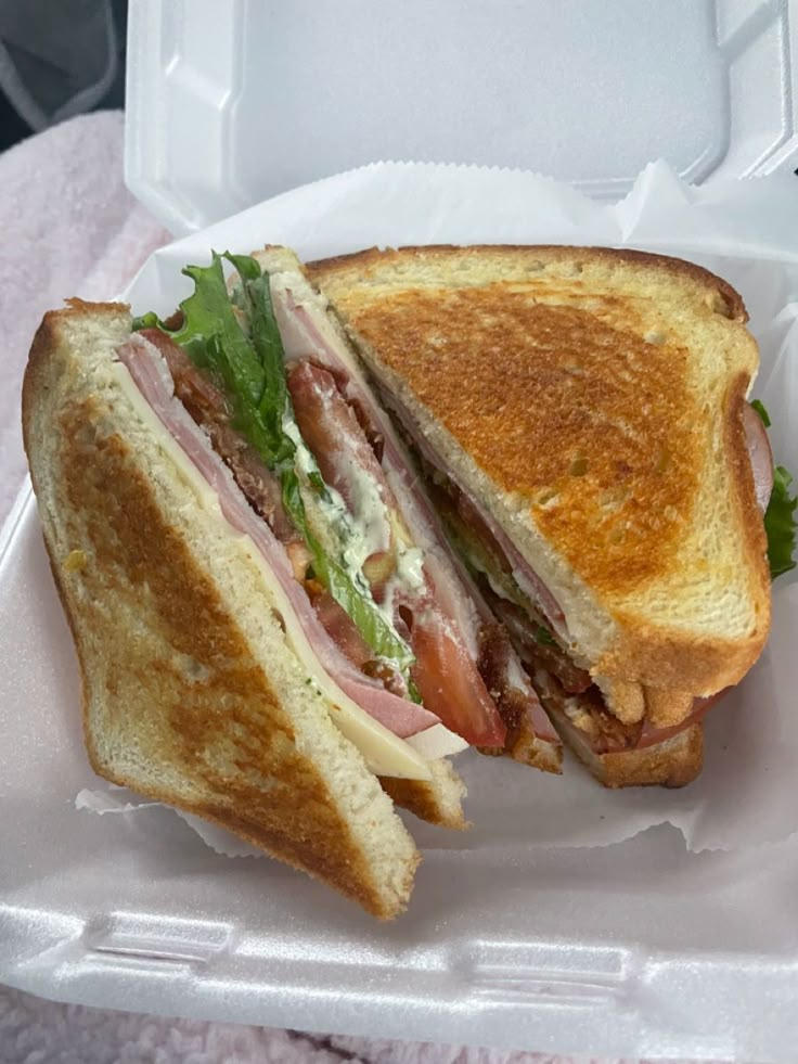 a sandwich in a foam container on a table