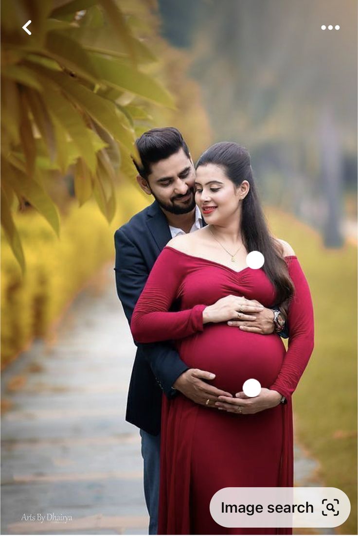 a pregnant couple standing next to each other