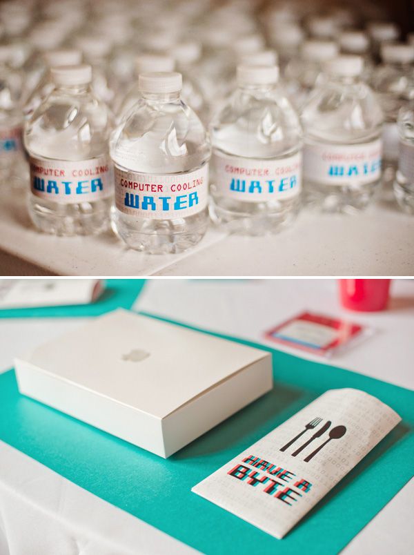 water bottles are sitting on a table next to an empty box and some napkins