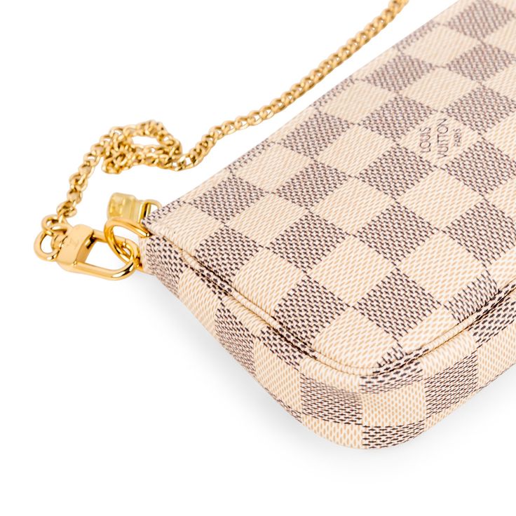 The Pochette is a petite accessory perfect to add to your Louis Vuitton day bag or simply wear it by itself if you only need a few items! The Pochette comes in the iconic Louis Vuitton damier Azur print recognisable anywhere. The gold chain that is attached as the top handle also detaches from one side, enabling you to hook it onto other accessories. Style your mini Pochette with your Louis Vuitton day bag. SPL Exterior Damier Azur Canvas Gold toned hardware Gold chain detachable from one side Z Louis Vuitton Mini Pochette, Things I Need To Buy, Accessories Style, Louis Vuitton Damier Azur, Abayas Fashion, Brown Canvas, Day Bag, Diaper Backpack, Bags Designer Fashion