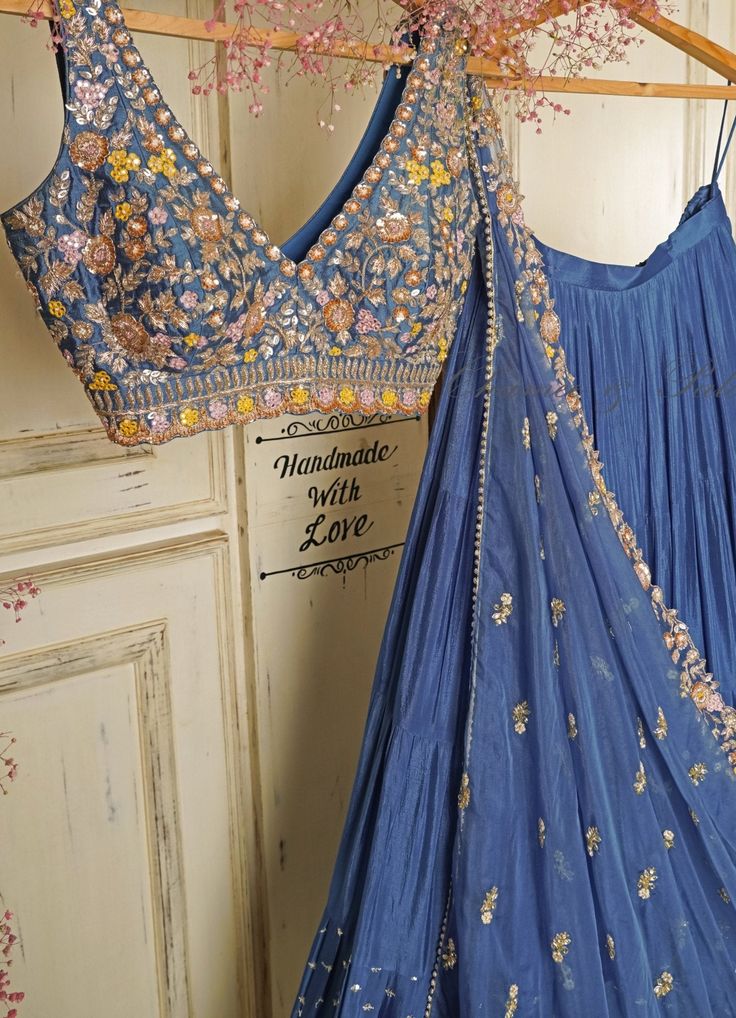 Summer Vibes ! Features a blue ruffled lehenga in soft georgette teamed with a zardosi and resham embroidered raw silk blouse in summer colours. Completed with a pre draped tulle dupatta with an embroidered border Composition : Lehenga- Georgette, Blouse-Silk, Dupatta-Tulle Care: Dry Clean Only and Vacuum Storage This product can be customised for sleeves, length of blouse and neckline Delivery : 6-8 weeks as the product is hand crafted. For more information and sizes please contact fabiliciousfashion@gmail.com or visit our Copenhagen studio.About the Designer : Born and brought up in the bustling city of Mumbai, Chamee and Palak come from a family of successful entrepreneurs and a deep-rooted love for textiles. Their childhood was filled with lively discussions and inspiring tales around Simple Lehenga, Trendy Outfits Indian, Indian Outfits Lehenga, Floral Lehenga, Lehenga Designs Simple, Traditional Indian Dress, Half Saree Designs, Salwar Kamiz, Indian Dresses Traditional