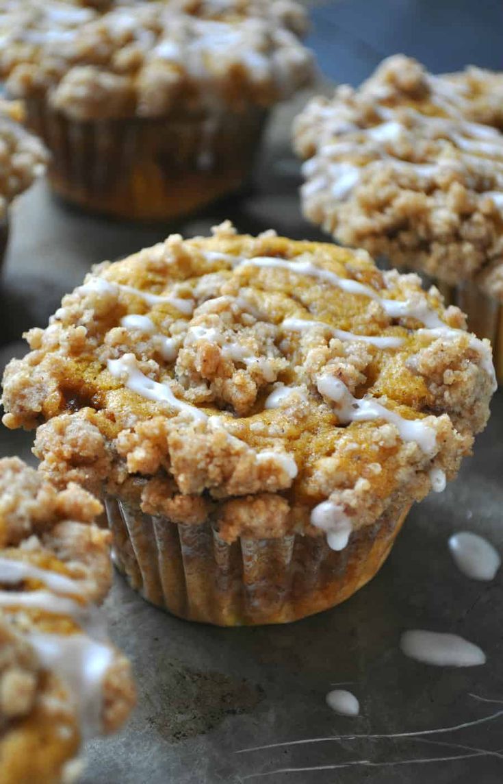 muffins with white icing and crumbs on top