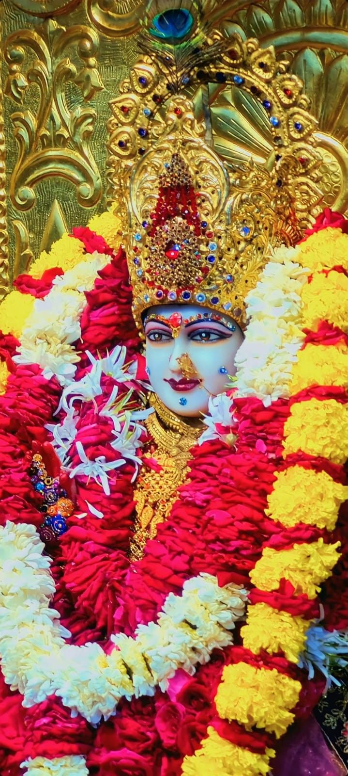 the statue is decorated with flowers and garlands