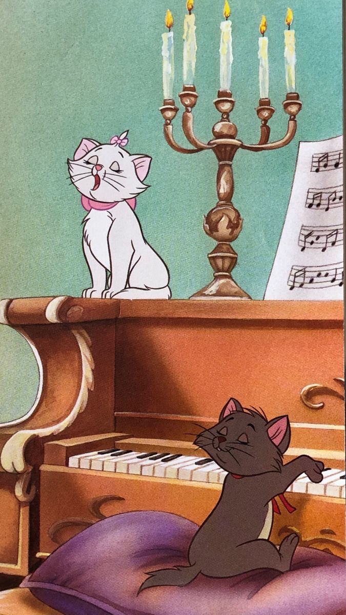 an image of a cat playing the piano with another cat sitting on top of it