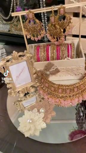 an assortment of jewelry is displayed on a table in front of other items that are for sale