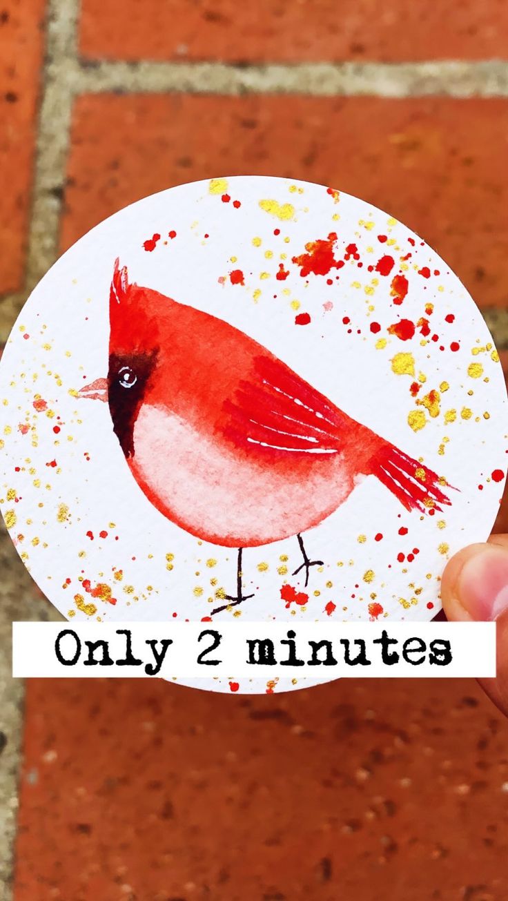 a hand holding up a red bird with the words only 2 minutes printed on it