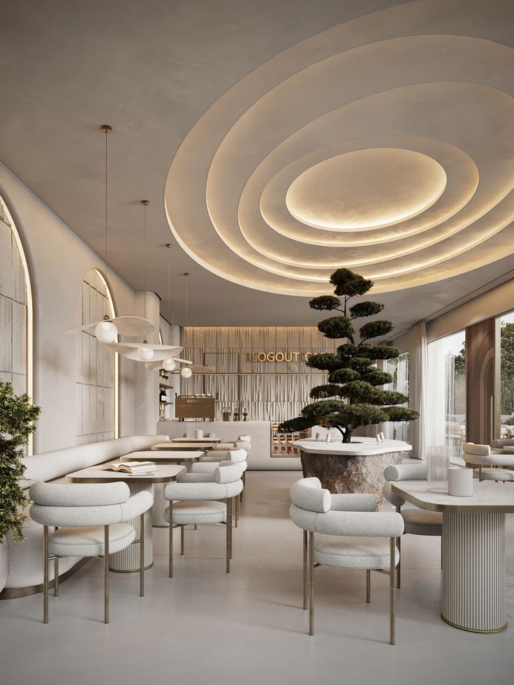 the interior of a modern restaurant with circular lights and white chairs, round trees in the center