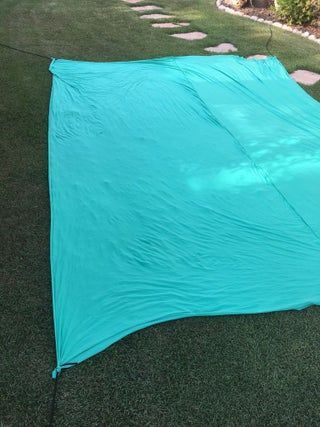 a blue tarp is laying on the grass