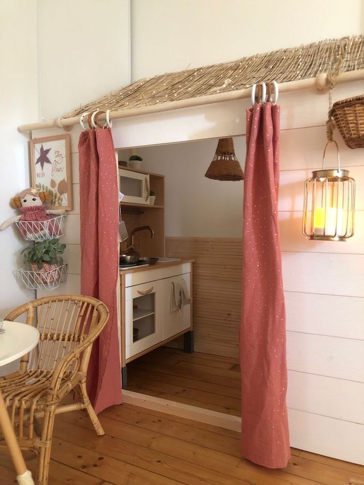 a kitchen area with a table and chairs