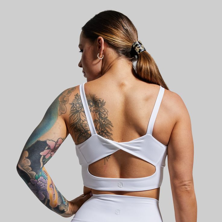 With an extended body, flattering twisted back design, and added coverage around the chest, this sports bra will truly be "Your Go To.” From sweaty Pilates sessions to hitting new PR’s in the weightroom, this bra provides maximum support without digging into your lats or shoulders resulting in superior comfort and performance. White Sports Bra With Built-in Padding, White Yoga Sports Bra With Built-in Padding, White High Stretch Sports Bra With Padding, White Sports Bra With Built-in Padding For Workout, White High Stretch Sports Bra With Built-in Padding, High Stretch White Sports Bra With Built-in Padding, White Compressive Sports Bra For Gym, Compressive White Sports Bra For Gym, White Activewear With Built-in Padding For Gym