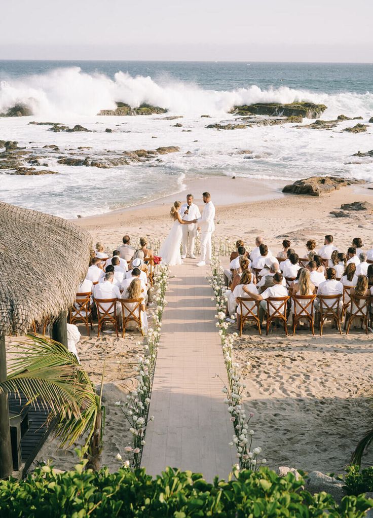 an outdoor wedding ceremony on the beach