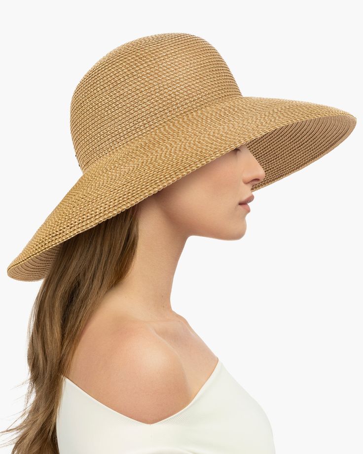 Made from partially recycled materials, our patented Squishee® straw has a classic look you will love. This sustainable product of man-made materials looks and feels like authentic raffia straw and is more durable than a hat made of natural fiber. If you have been searching for a woman's designer packable hat for sale, this is a style you will use for many years to come. Bella rolls and folds into a tote bag for travel and will emerge wrinkle-free when unpacked. Eric Javits' Squishee® hats are k Packable Hat, Hat Blocks, Bag For Travel, Hats For Sale, Hat Making, Sun Hat, Natural Fibers, Sun Hats, Classic Looks