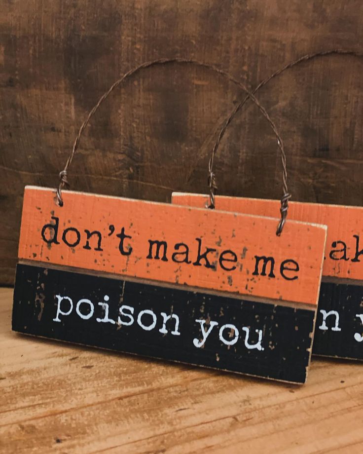 two wooden signs that say, don't make me ask the poison you