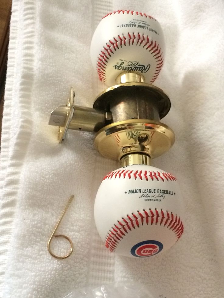 two baseballs and a fishing hook on a towel