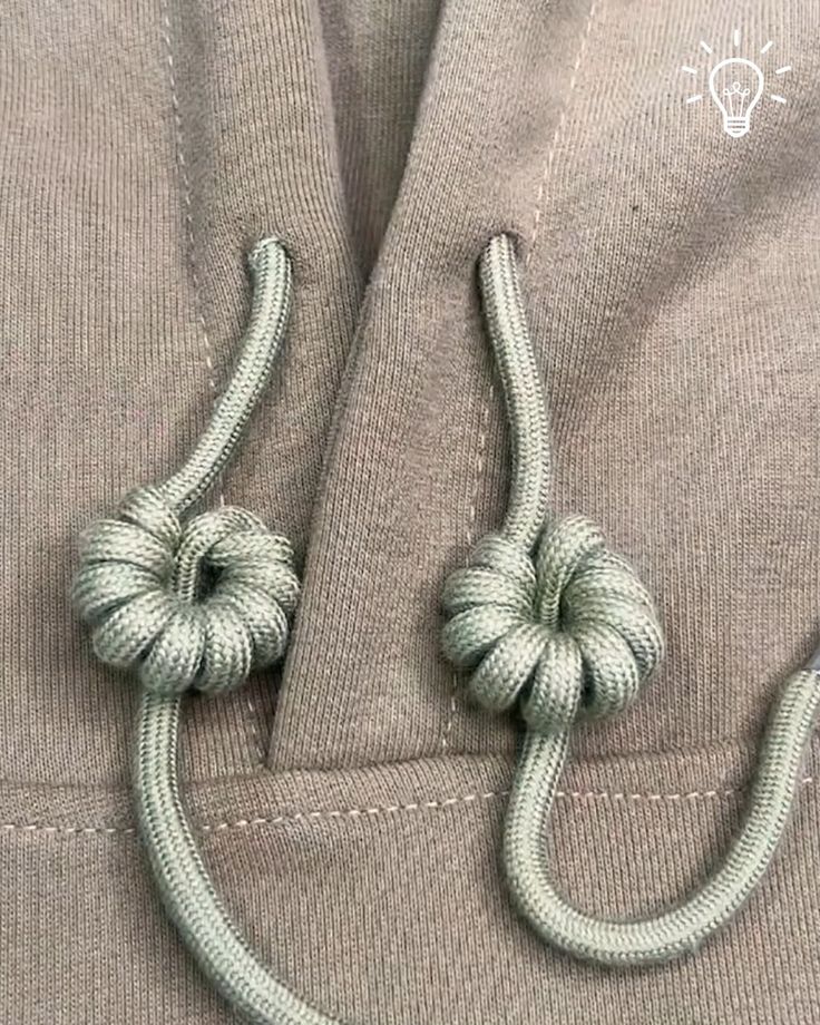 a close up of a knot on the side of a jacket with two loops attached to it