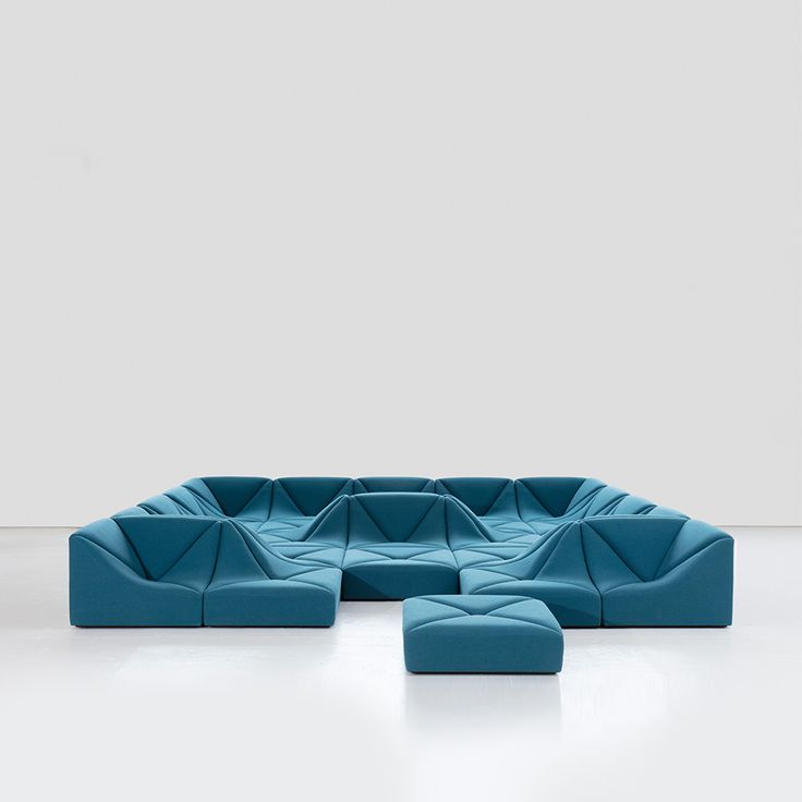 a blue couch sitting on top of a white floor