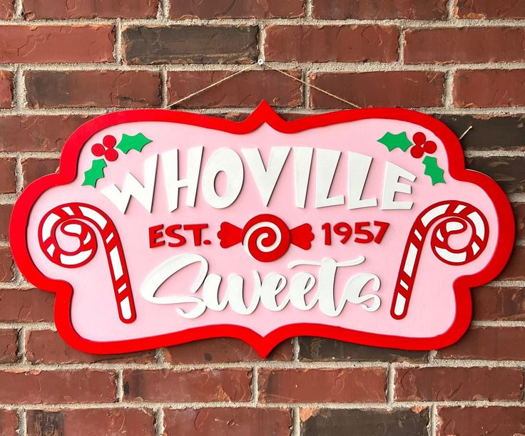 a sign that is on the side of a brick wall saying whoville sweeties