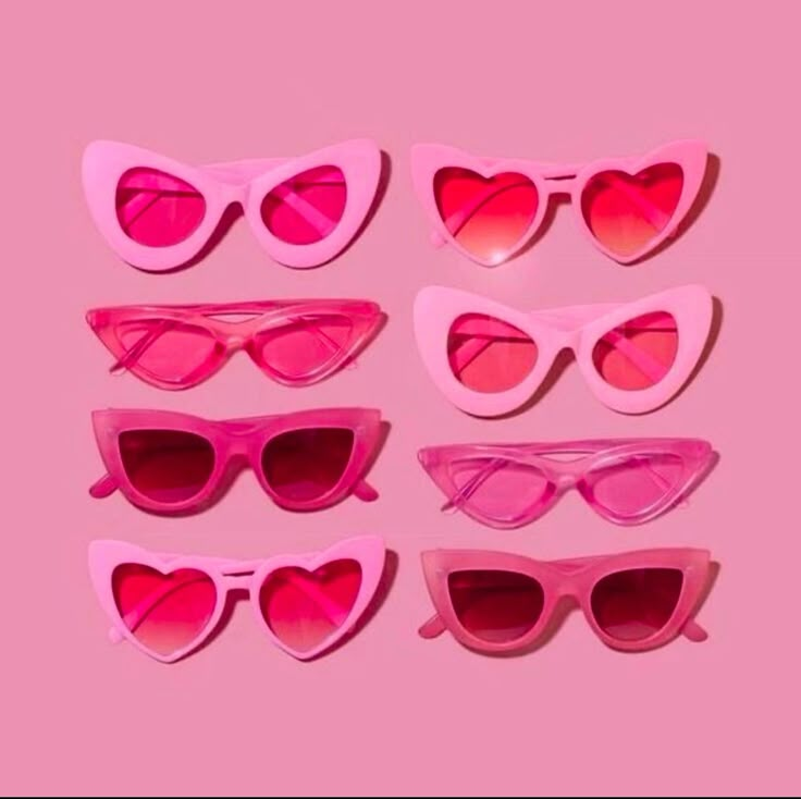 six pairs of pink heart shaped sunglasses on a pink background